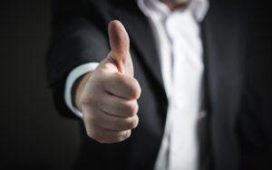 Businessman holding thumb up